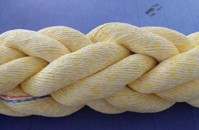 Close-up of yellow 8-strand mooring rope with a coloured tracer yarn